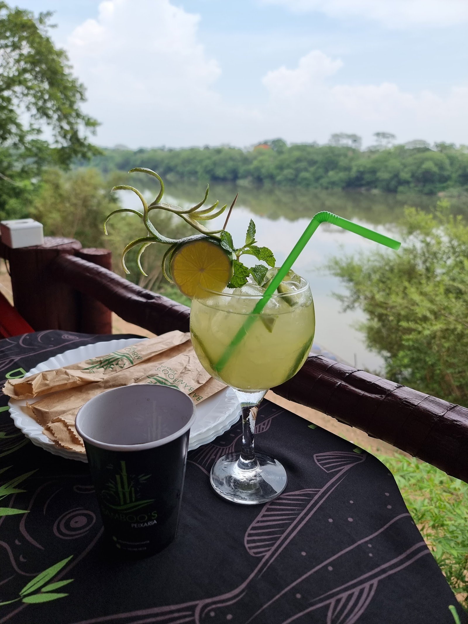Caipirinha gelada na varanda da Bamboo's com a vista do rio Cuiabá ao fundo, entre o verde da mata ribeirinha